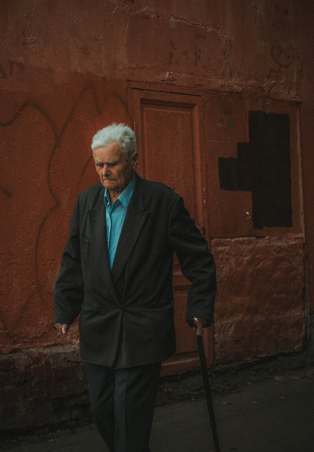 Studio portrait of a senior European man with gray hair in a suit